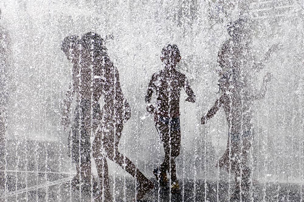 Kids playing in the splash pad of downtown Phoenix--one of the top free things to do for families.