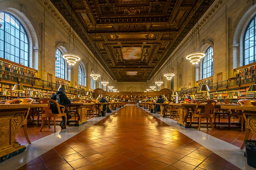 People sitting quietly at NYC Public Library, one of the top free things to do in New York with kids