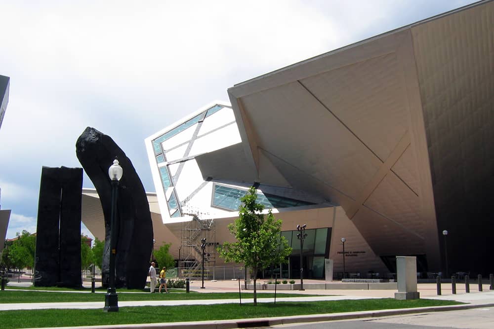 Two people walking around an art installation on the lawn outside of the Denver Art Museum, a great free attraction in Denver.