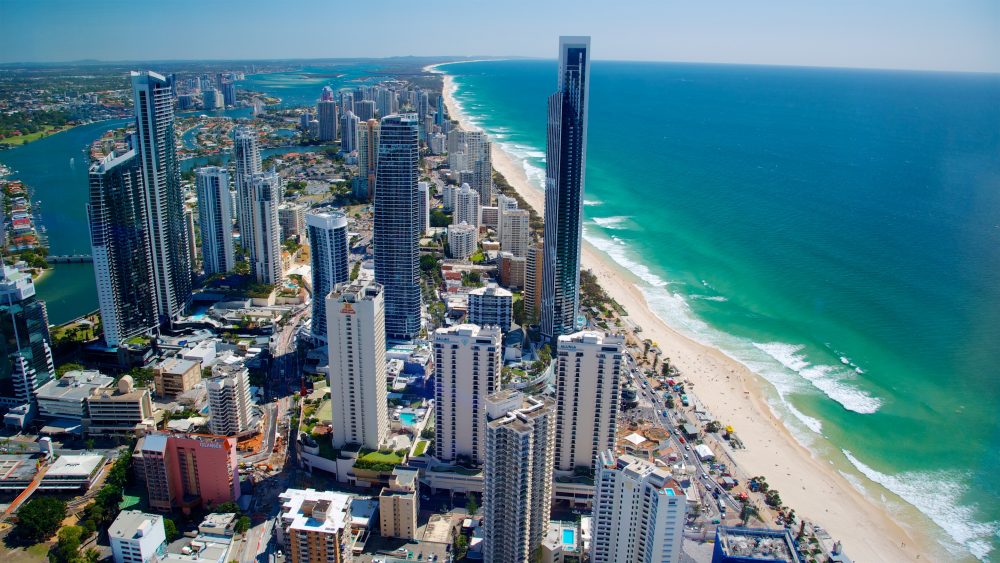 Aerial view of Surfer's Paradise with high-rise buildings and the crashing surf on the shore