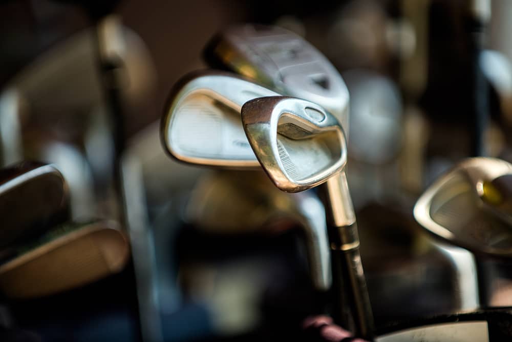 Close-up of golf clubs being shipped, one of the ways you can enjoy a cheap golf vacation to Myrtle Beach. 