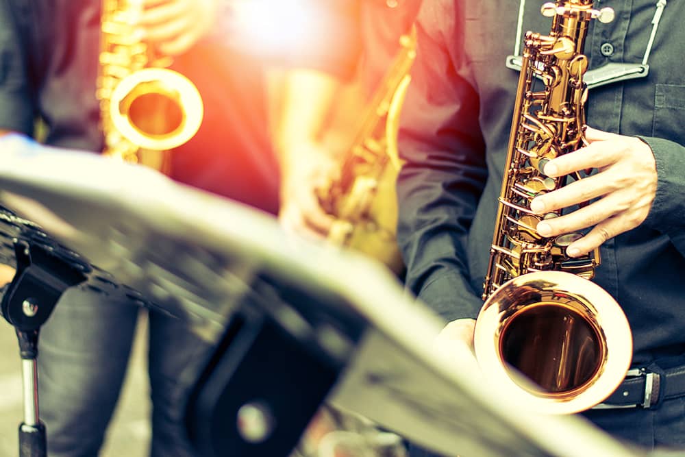 A blurred close up of musicians playing their brass instruments at the City Park Jazz concert in Denver, a free thing to do in the city.