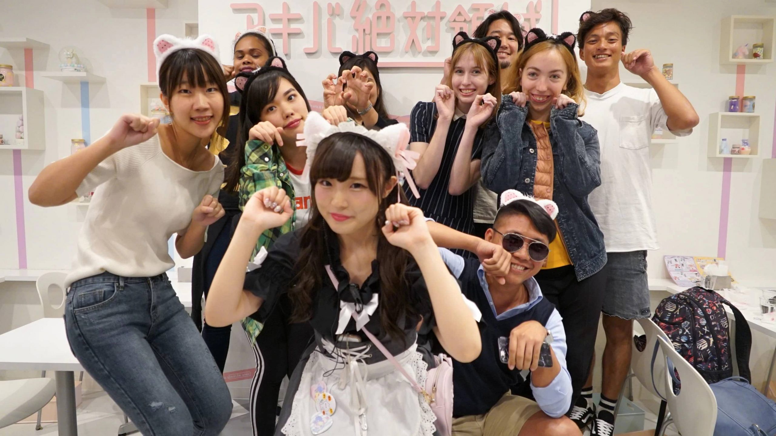 A group posing in a maid cafe in Tokyo