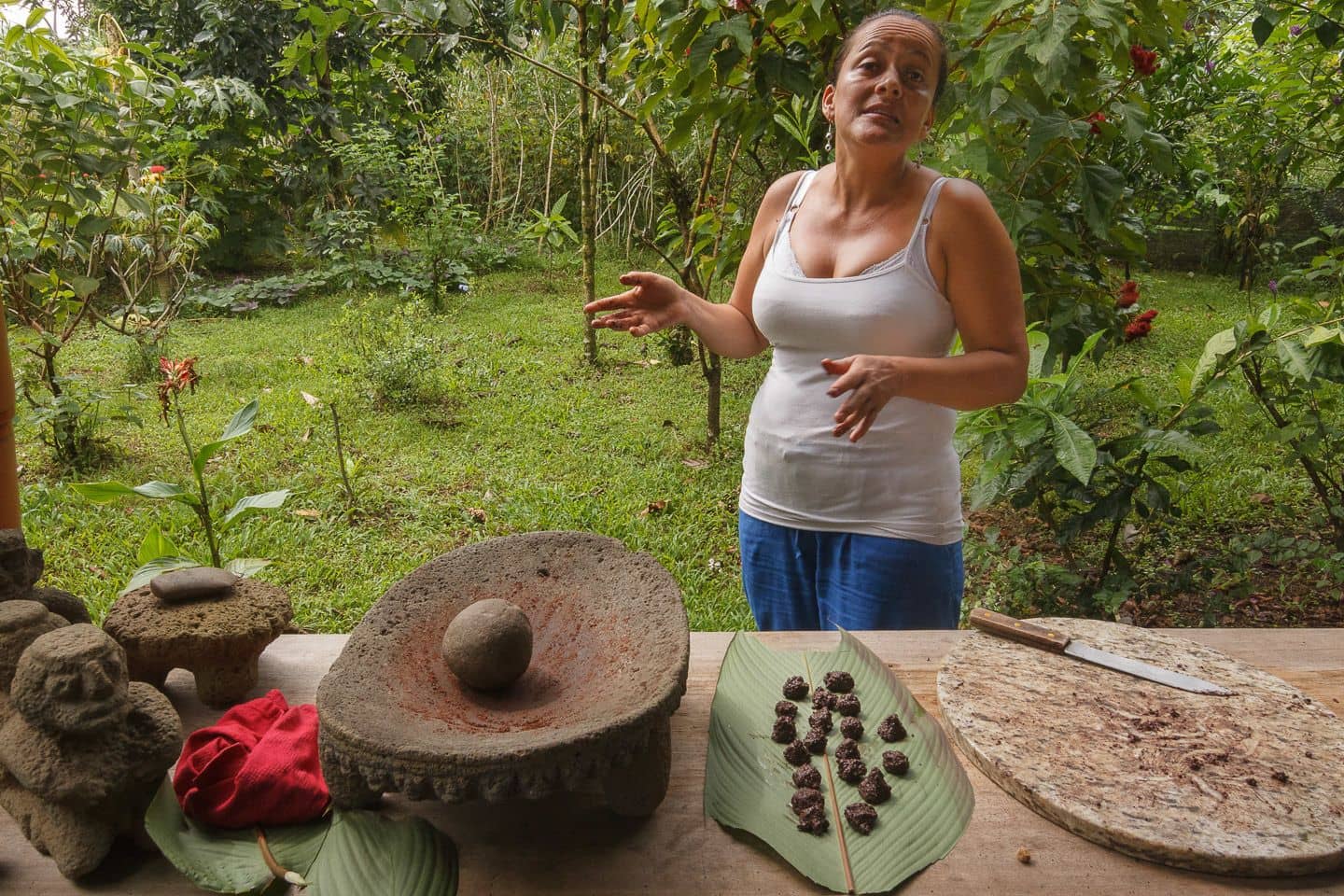 A woman showing how to make chocolate with traditional tools in Costa Rica