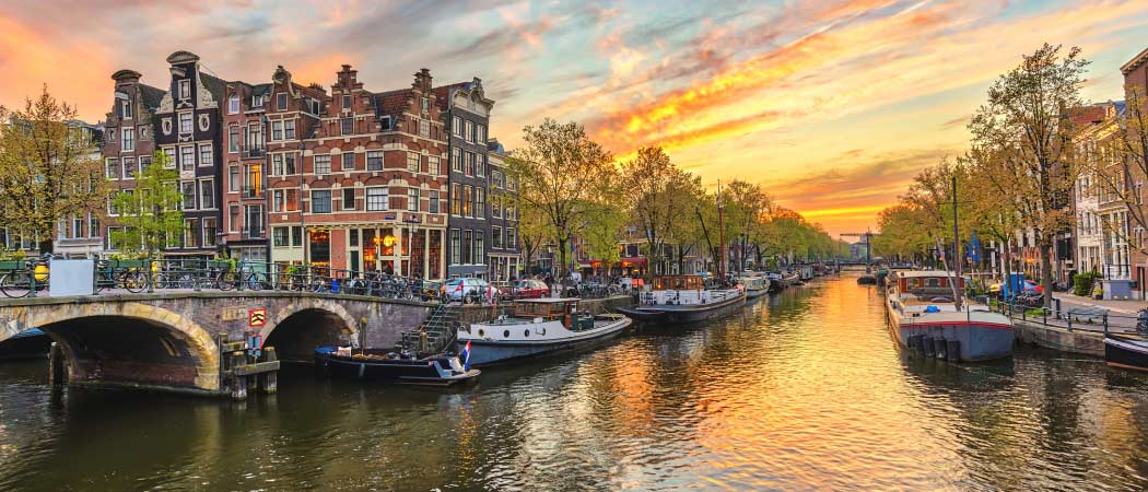 Views of buildings and boats on the canals of Amsterdam