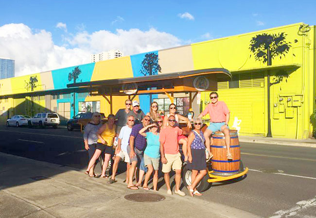 Group stands in front of Beer Bike while on tour in Honolulu