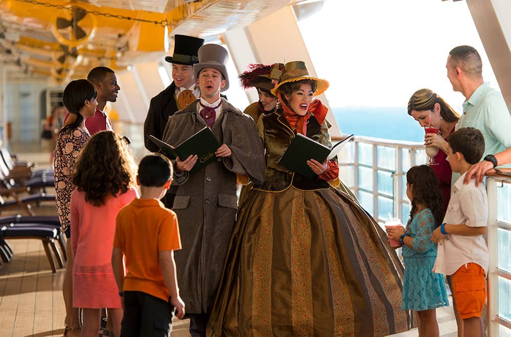 Families singing carols at Disney Dream Kids singing along with carolers at Disney Dream