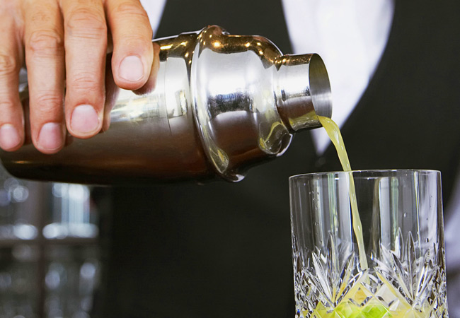 – Cocktail being poured out of Martini shaker