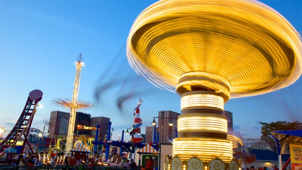 Luna Park, Coney Island. Photograph of colourful spinning ride in motion. 