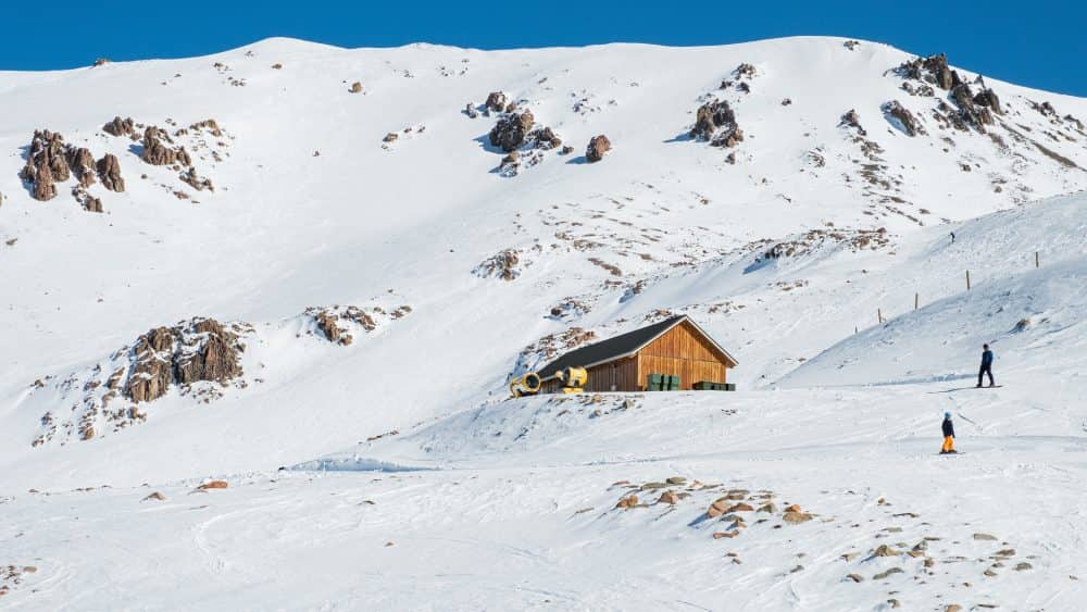 People on a mountain with a ski lodge
