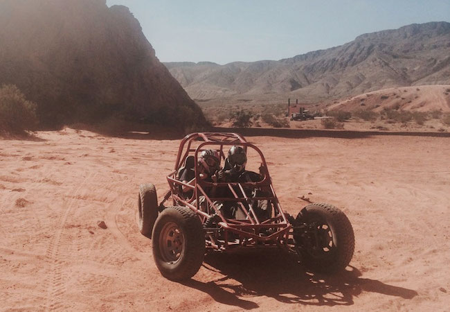 Two people in dune buggy in Las Vegas desert