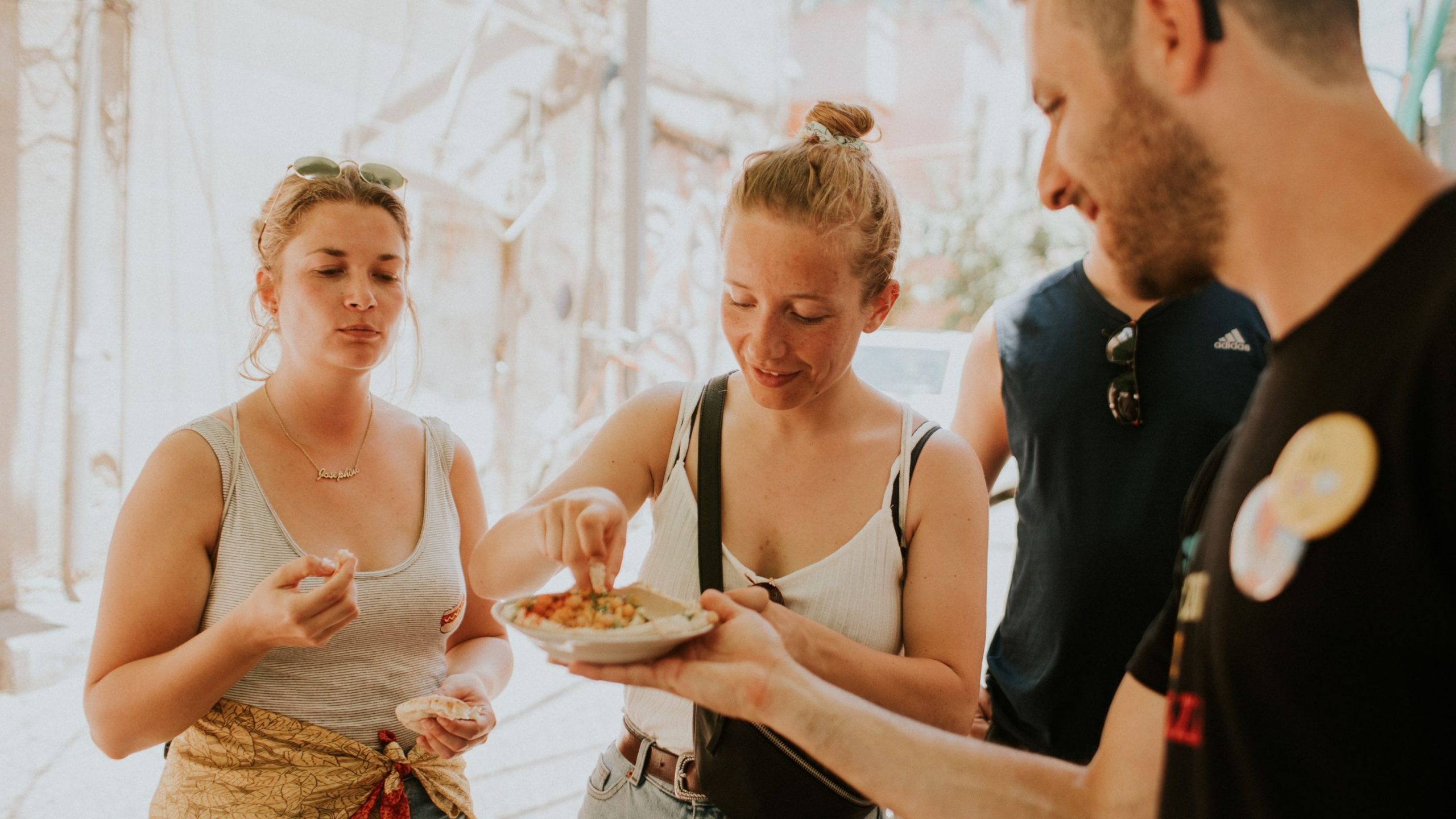 Two women eating hummus on a vegan food tour in Tel Aviv