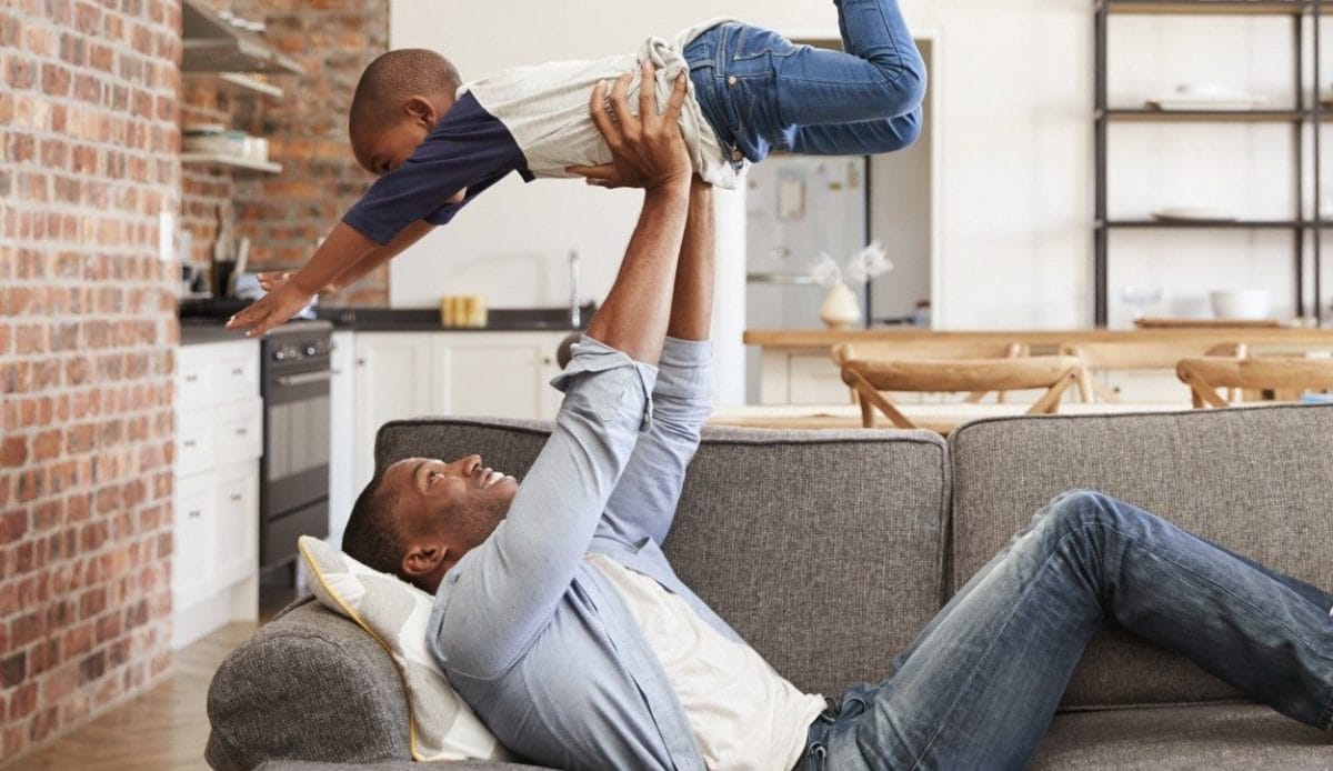 Father and son playing in their living room