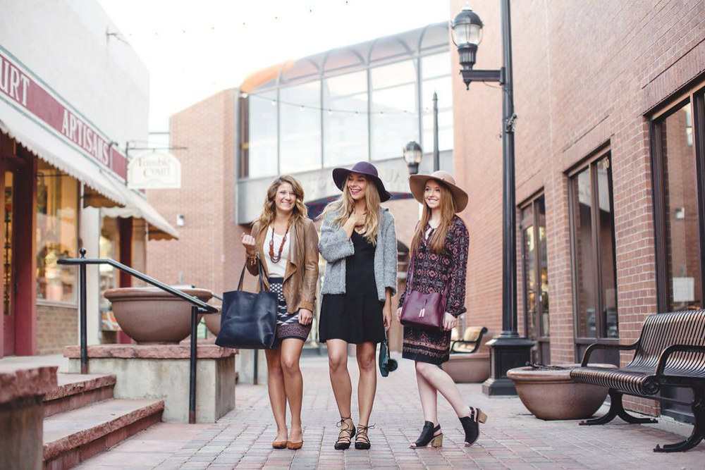 three women model boutique styles in the street