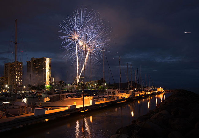 Fireworks launched over marina at night in Honolulu