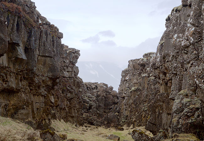 Grass valley between flanking rocky cliffs in Thingvellir National Park in Reykjavik