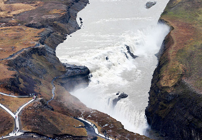 Ariel view of large river and waterfalls with overlook in Reykjavik