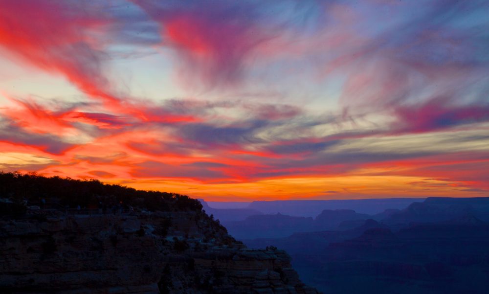 View of a bright orange and pink sunset at the Grand canyon