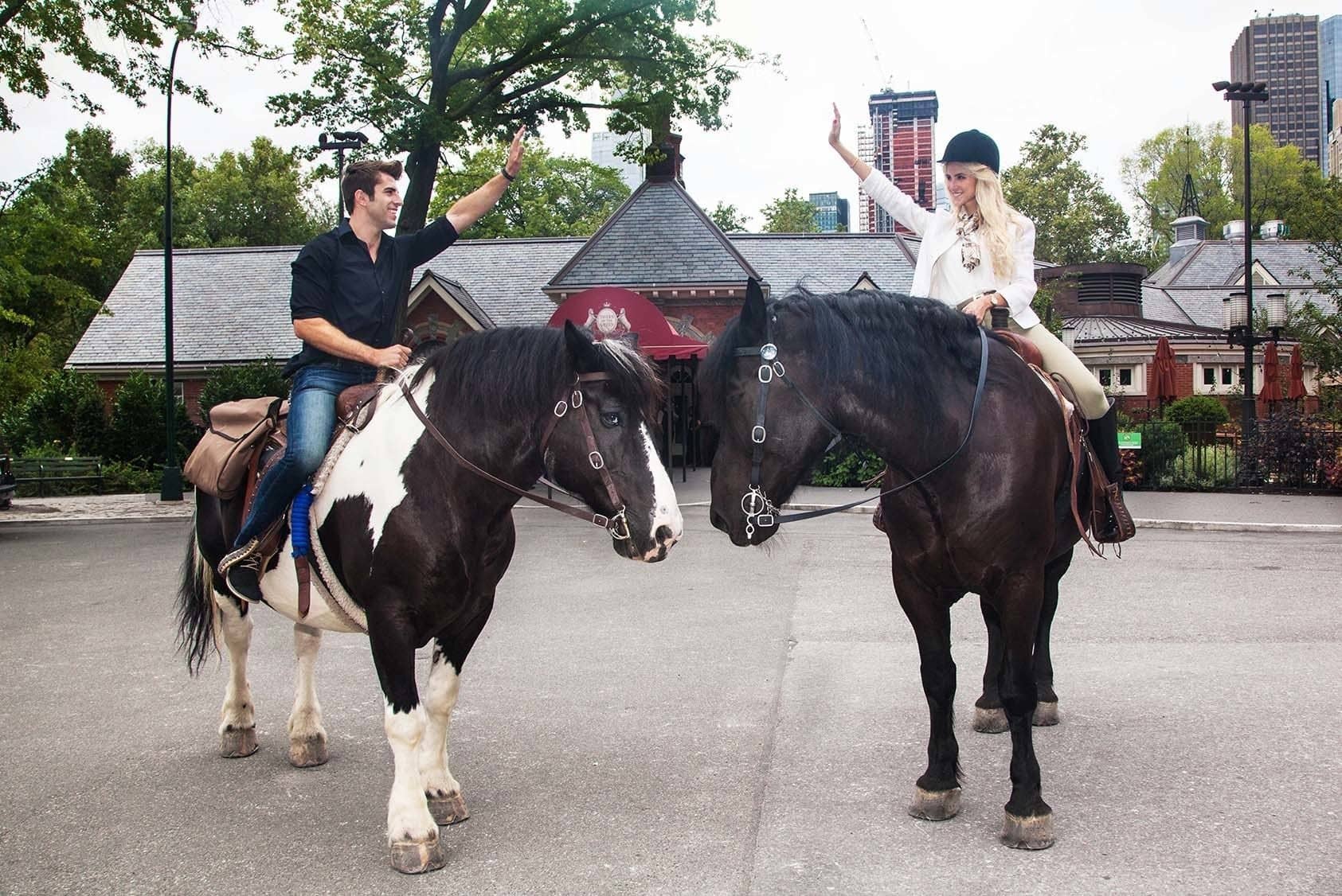 A couple giving a high five while Horseback Riding in Central Park in New York City