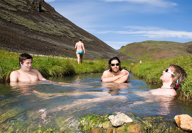 Group sits in a Geothermal stream in Iceland