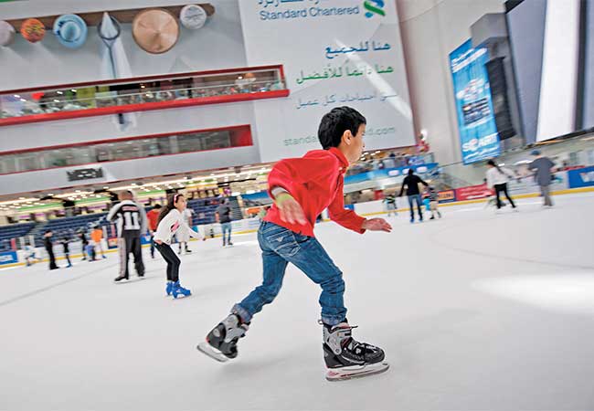 Boy ice skating in The Dubai Mall