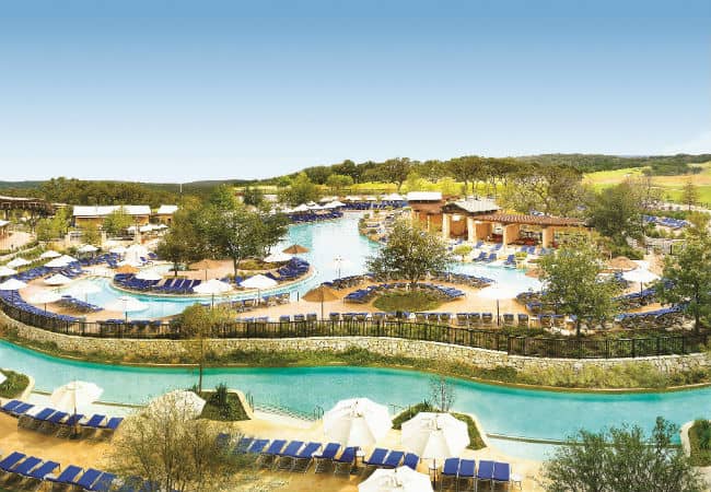 The pool and lazy river with blue lounge chairs at the JW Marriott San Antonio Hill Country Resort & Spa in San Antonio, Texas.
