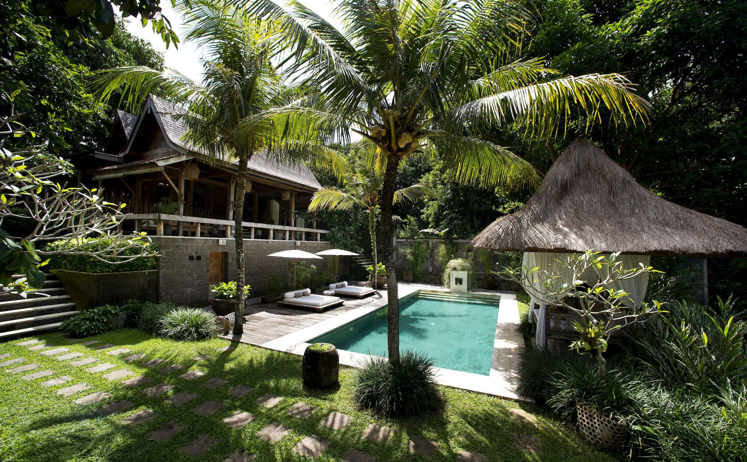 The outdoor pool and lounge area on a sunny day at the Kalapa Boutique Resort & Yoga Retreat in Bali.