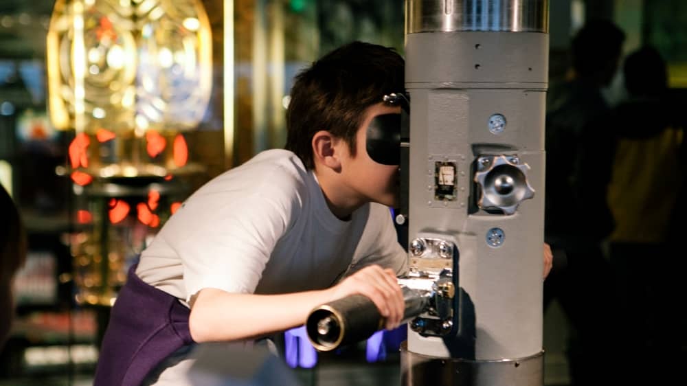 Kid using a periscope at the Museum of History and Industry