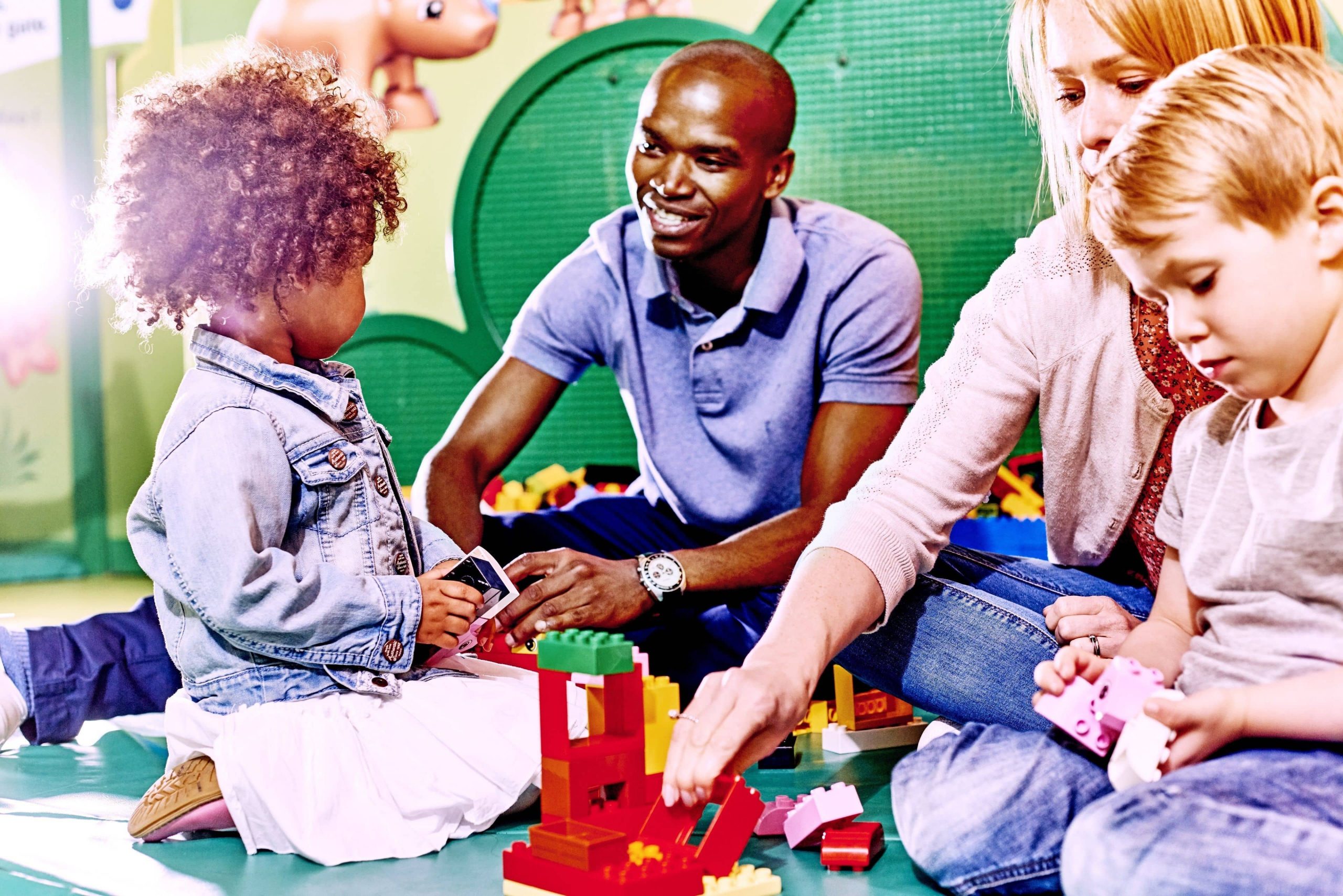 Kids and parents playing together with Legos