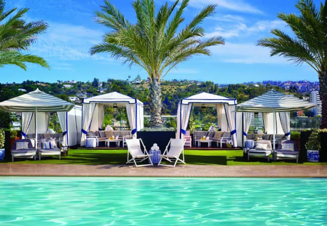 London West Hollywood’s turquoise pool with cabanas and lounge chairs scattered across the deck.
