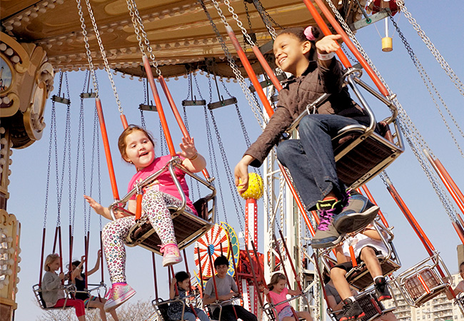 Kids in the swing ride at Coney Island in New York