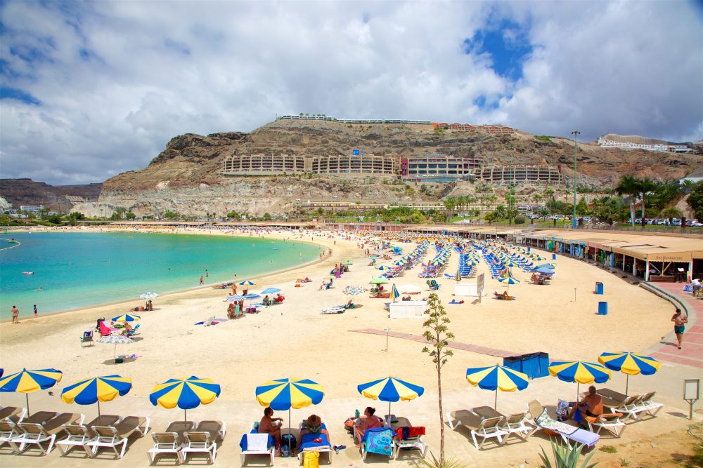 Bright umbrellas and tourists on Amadores Beach, Las Palmas Island