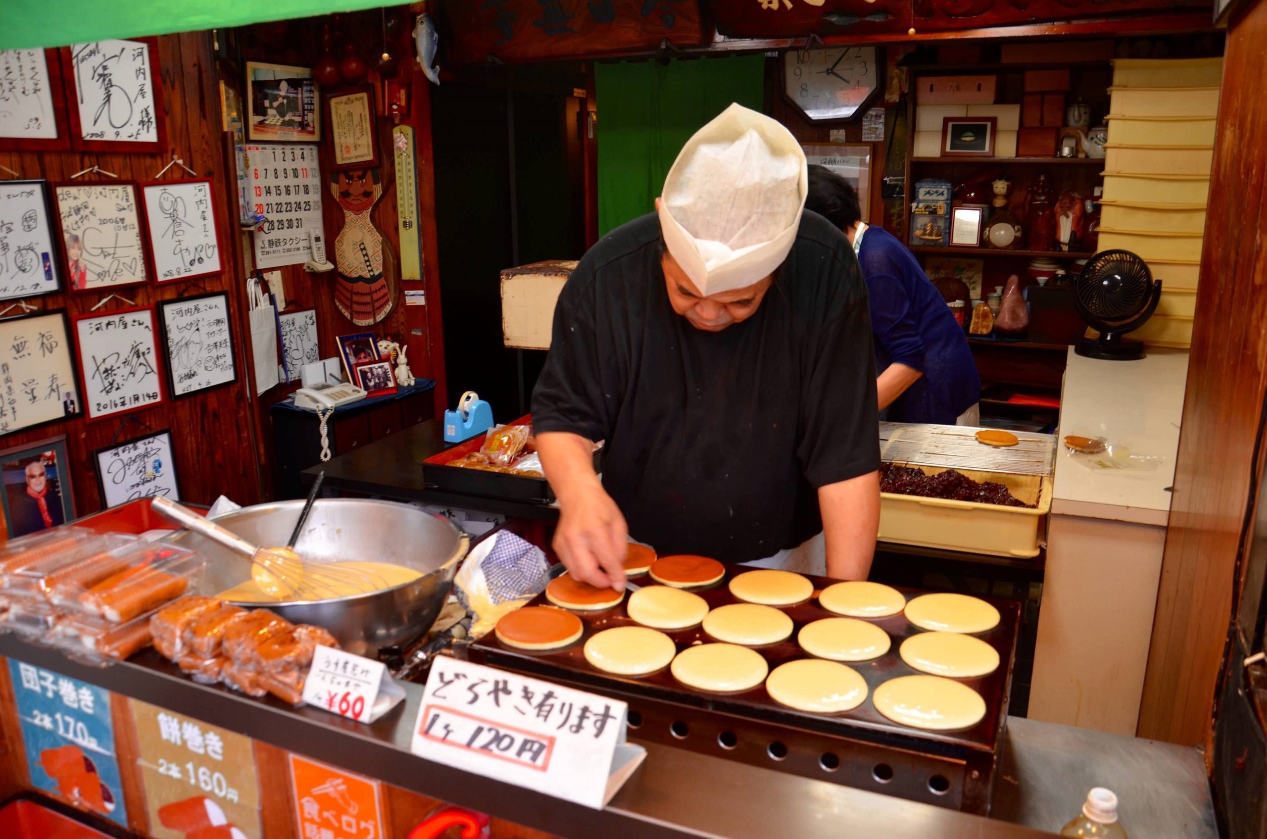 Man making little sweet pancakes on a grill in Osaka Japan