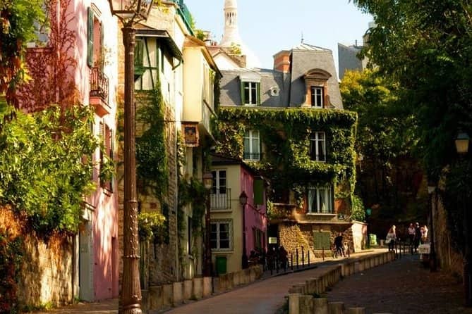 Beautiful houses line a cobblestone street in the charming neighborhood of Paris, Marais.