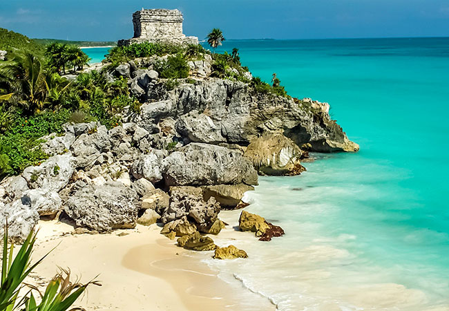 Ancient stone structure along cliff to the ocean in Cancun