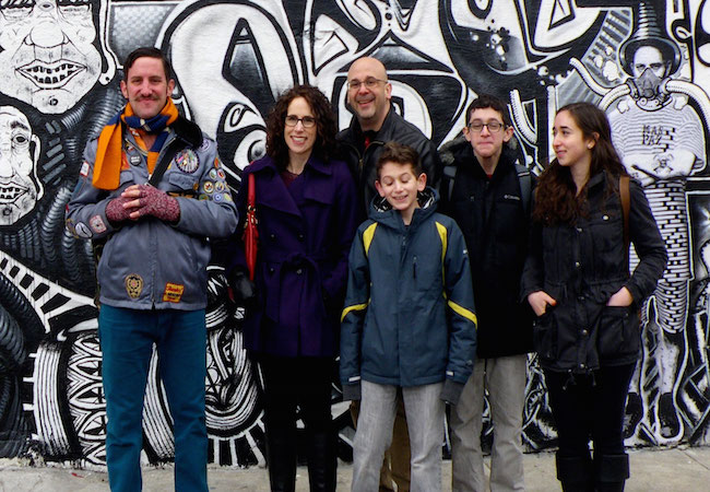 Tour group in front of mural in New York City