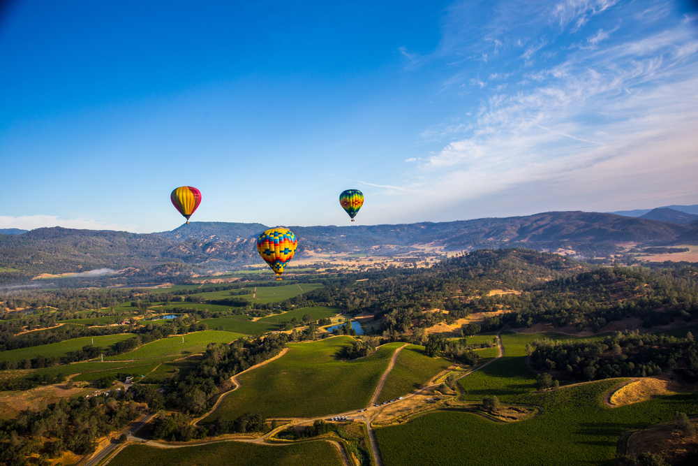 three colorful hot air balloons above Napa Valley
