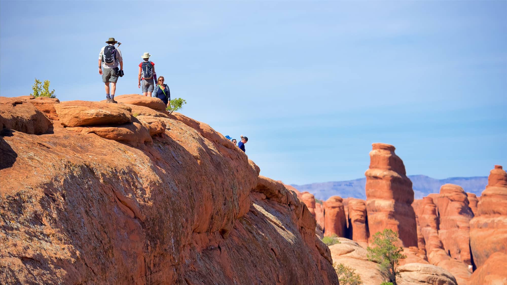 People hiking in Arches National Park on a visit in spring