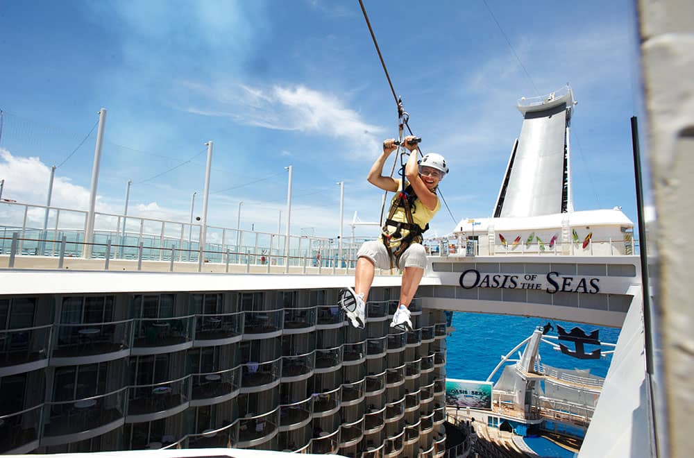 A guest having fun while doing zip line Zip line aboard the Oasis of the Seas