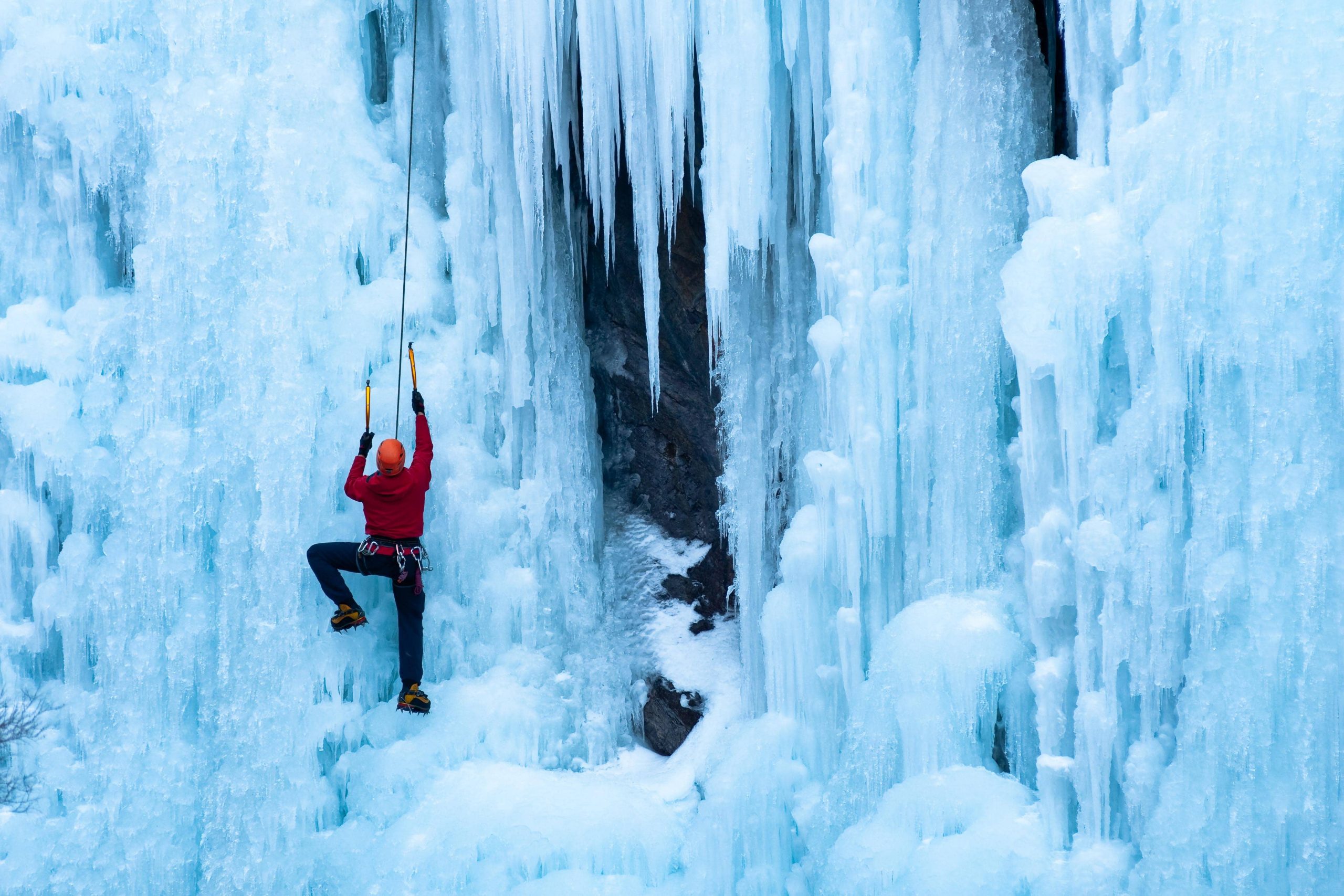 person climbing ice wall at ouray ice park, colorado