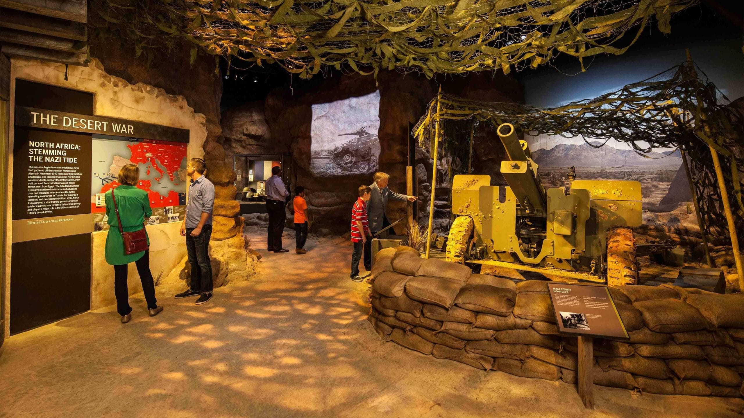 People exploring an exhibit of memorabilia in the National World War II museum