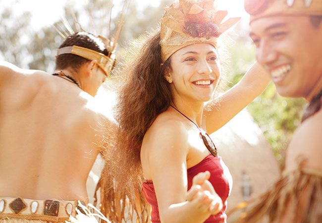 Three performers smiling during luau in Honolulu