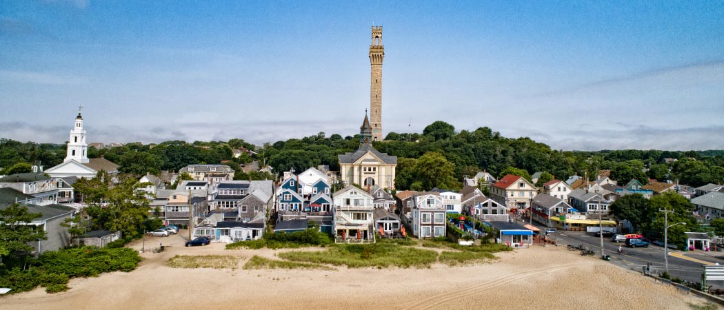 Aerial view of a beach and coastal buildings in Provincetown