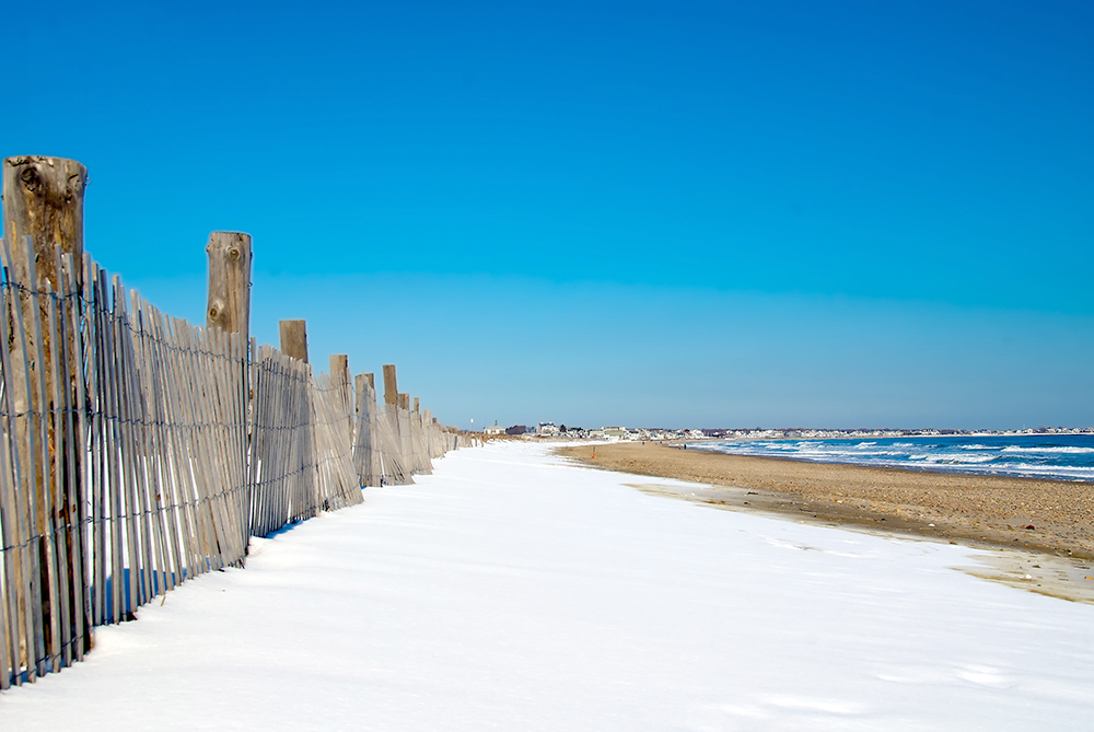 Snow covering the sand on the shores of Duxbury on a winters day.