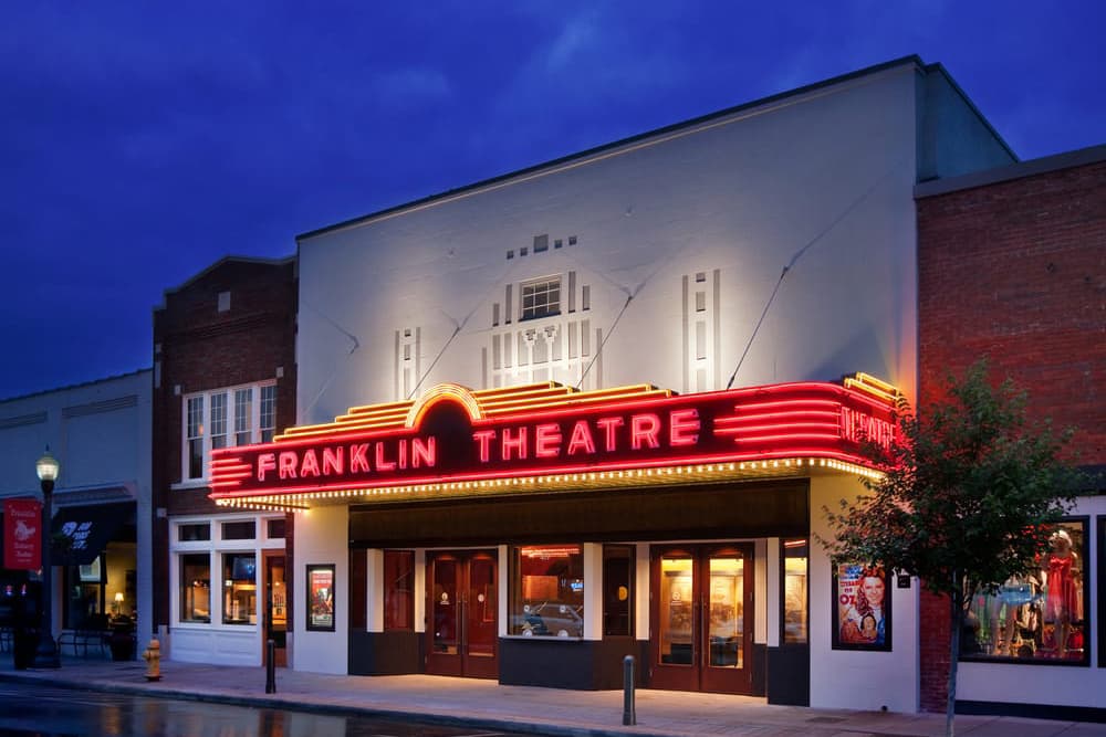 The historical Franklin Theater light up at night in the staycation city Franklin