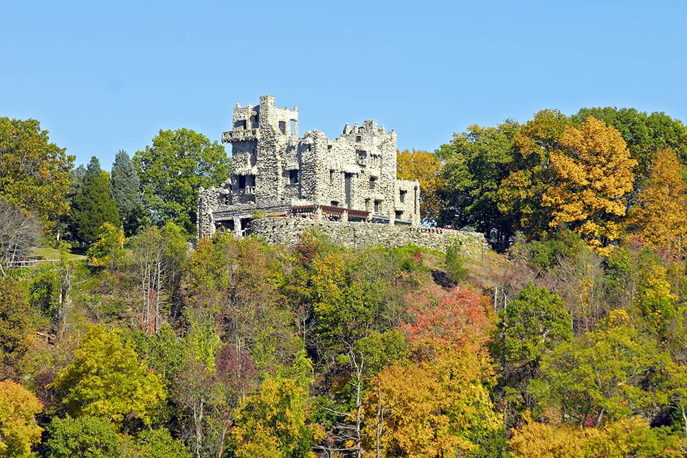 Gillette Castle, covered by green and orange trees, in East Haddam.