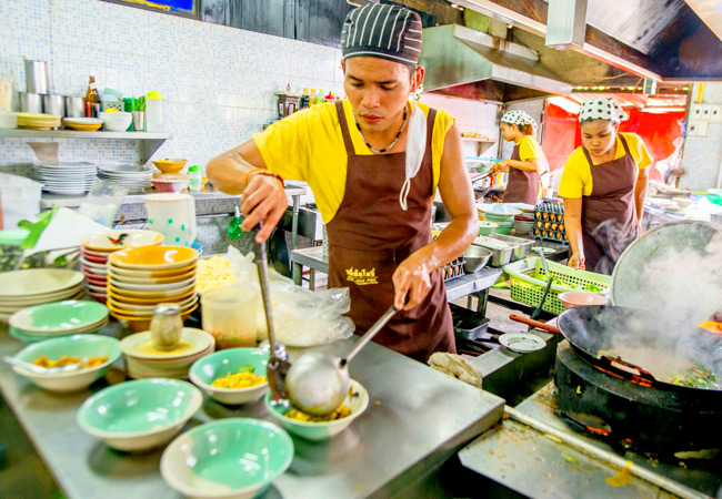 Chef makes food in a restaurant in Thailand