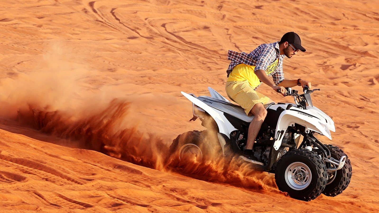 Riding a quad bike in the desert during Dubai travel adventures