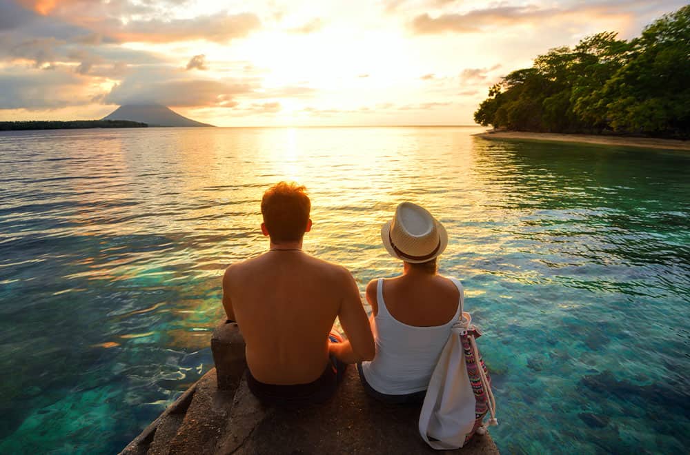 Couple looking at the sunset in Caribbean tropical beach A Romantic escape in a cruise line private island