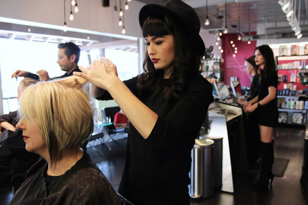 woman getting her hair styled in hip salon